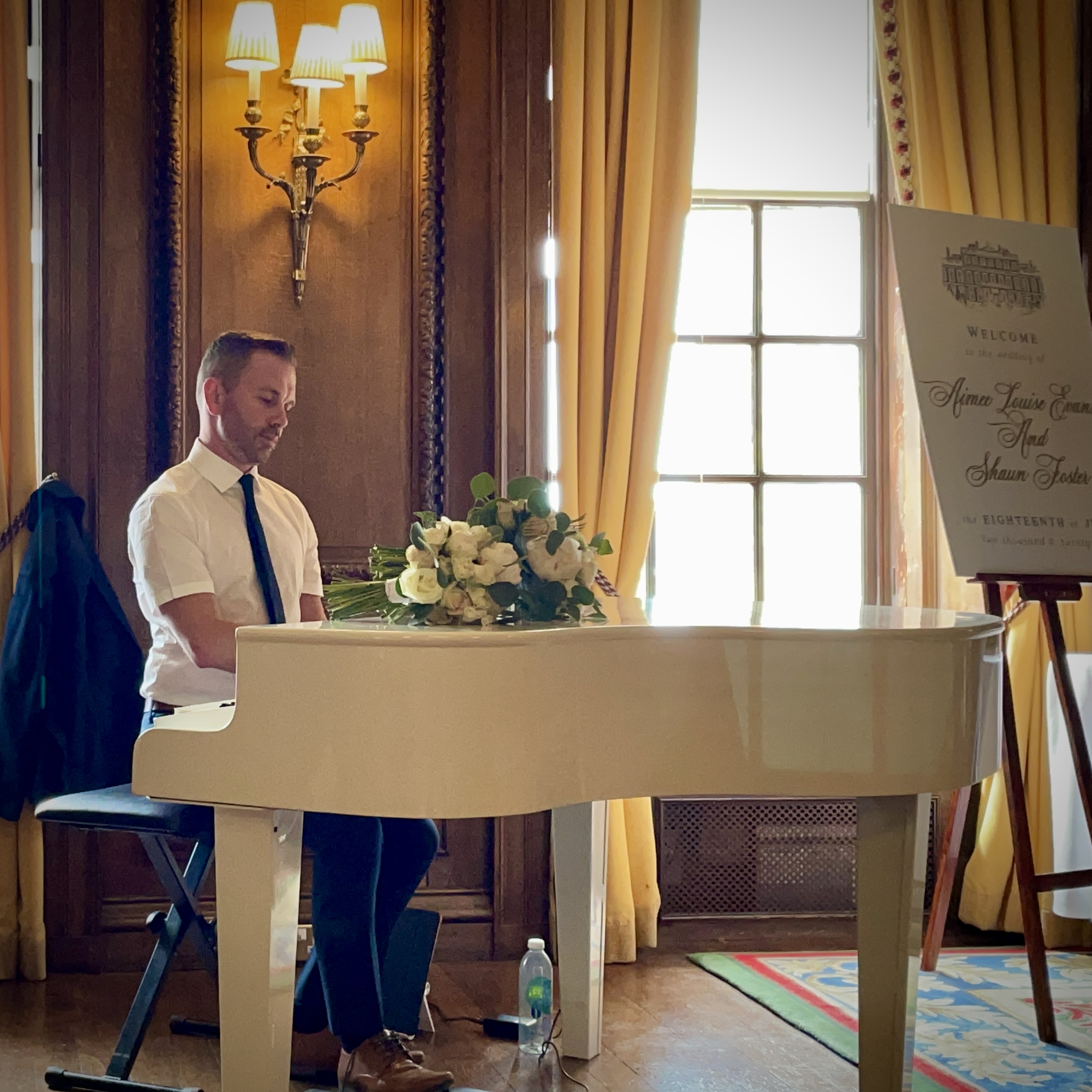 Wedding Pianist Craig Smith performs at a Knowsley Hall drinks reception on his white portable baby grand piano