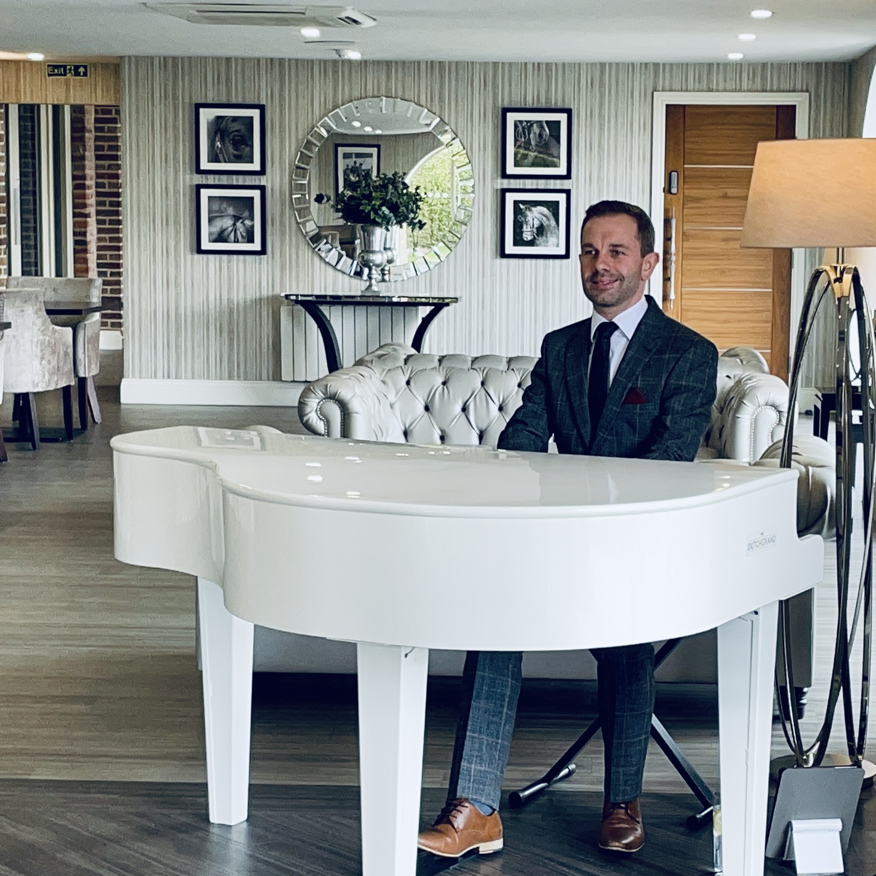 Wedding pianist Craig Smith plays his white piano in the bar at a Merrydale Manor wedding