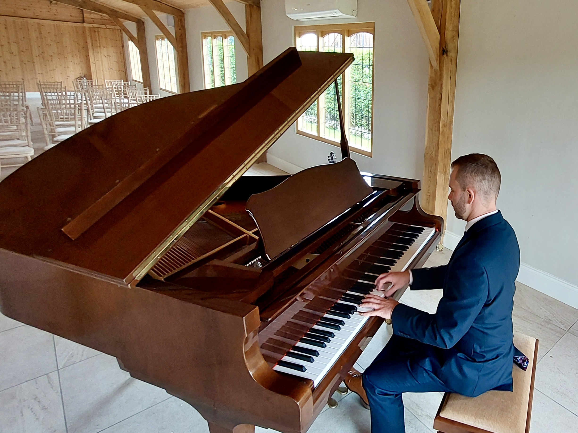Wedding pianist Craig Smith plays the piano ahead of a Merrydale Manor wedding ceremony