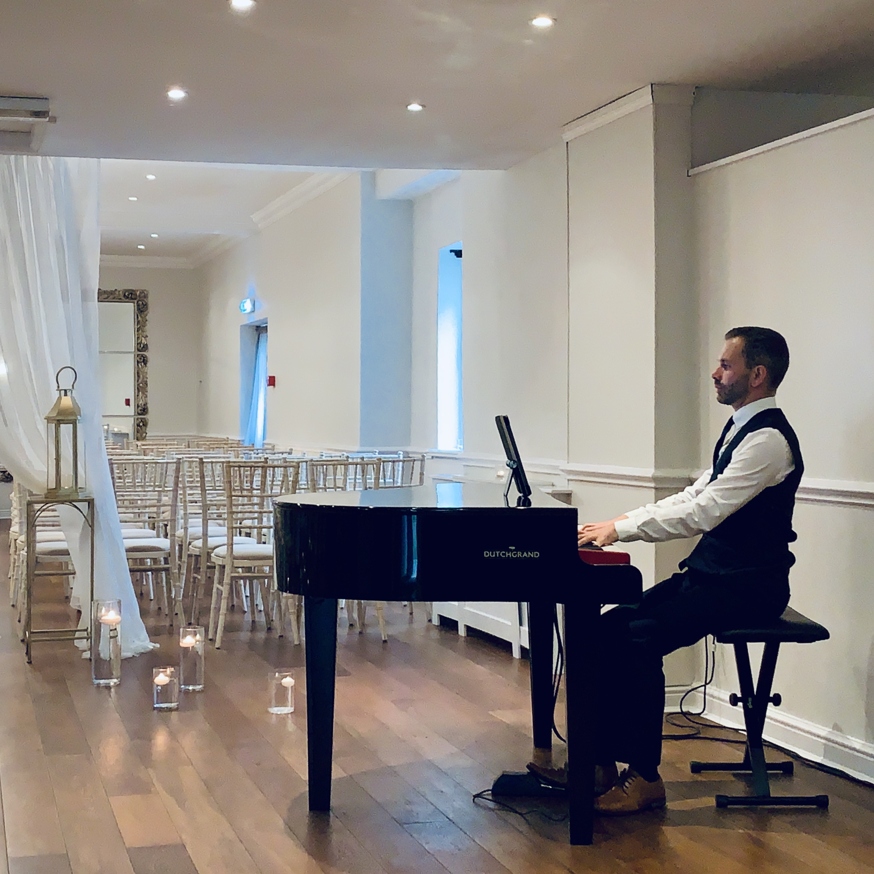 Recommended wedding pianist Craig Smith plays his black baby grand piano ahead of a ceremony at Sparth House